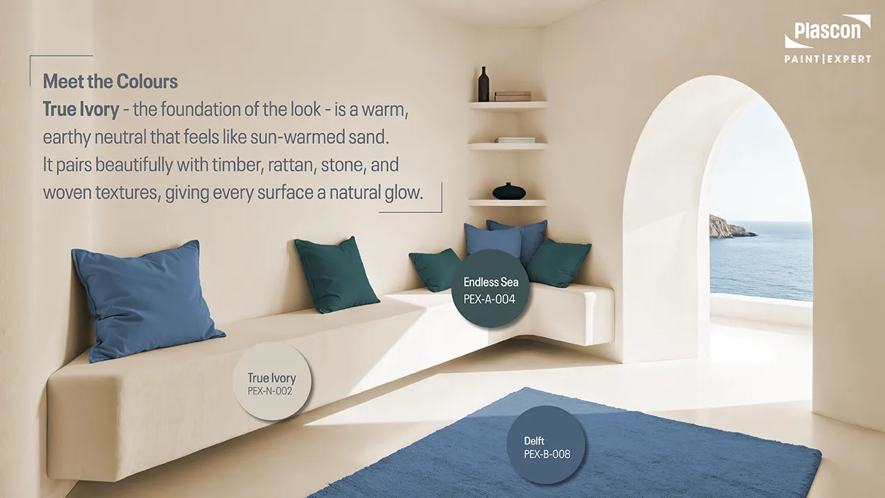 Warm True Ivory interior with built-in seating, ocean view and cushions in Endless Sea and Delft, illustrating a calm coastal colour palette.